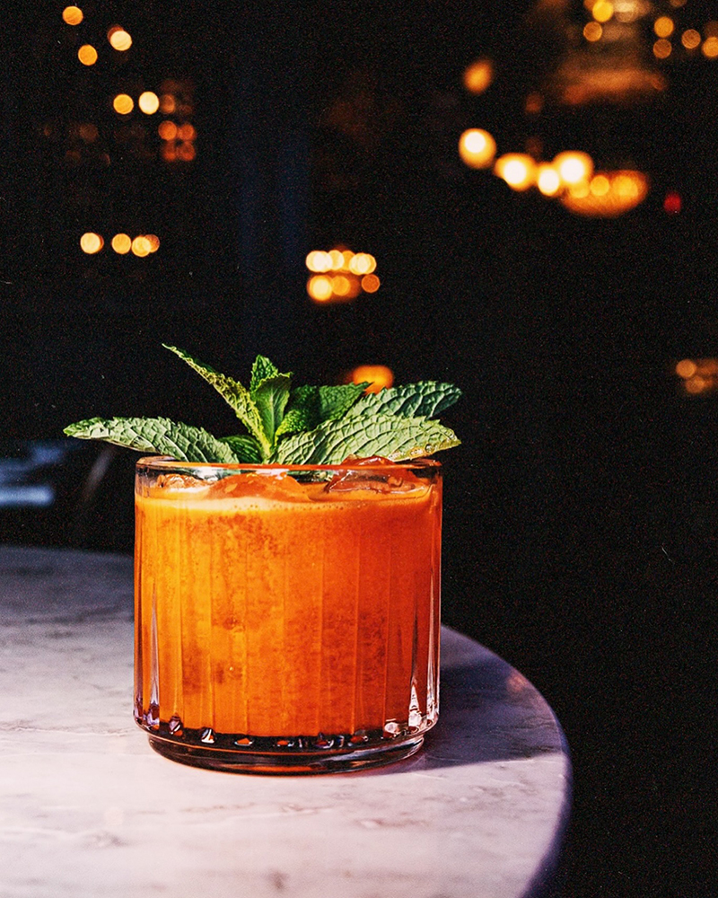 Orange drink with mint garnish