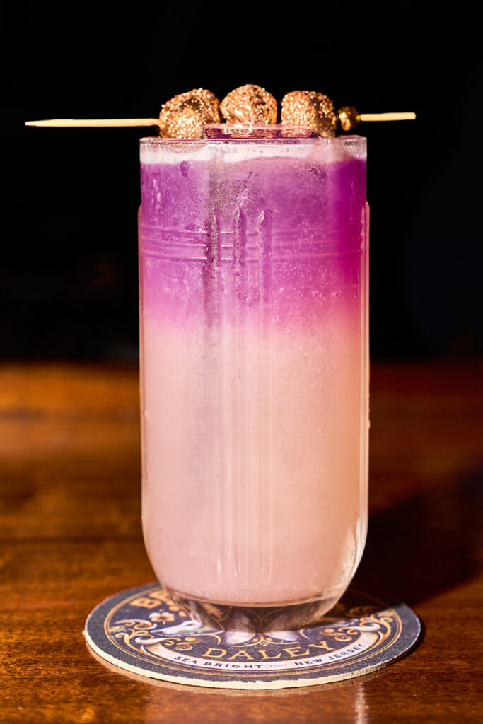 Colorful layered drink with garnish