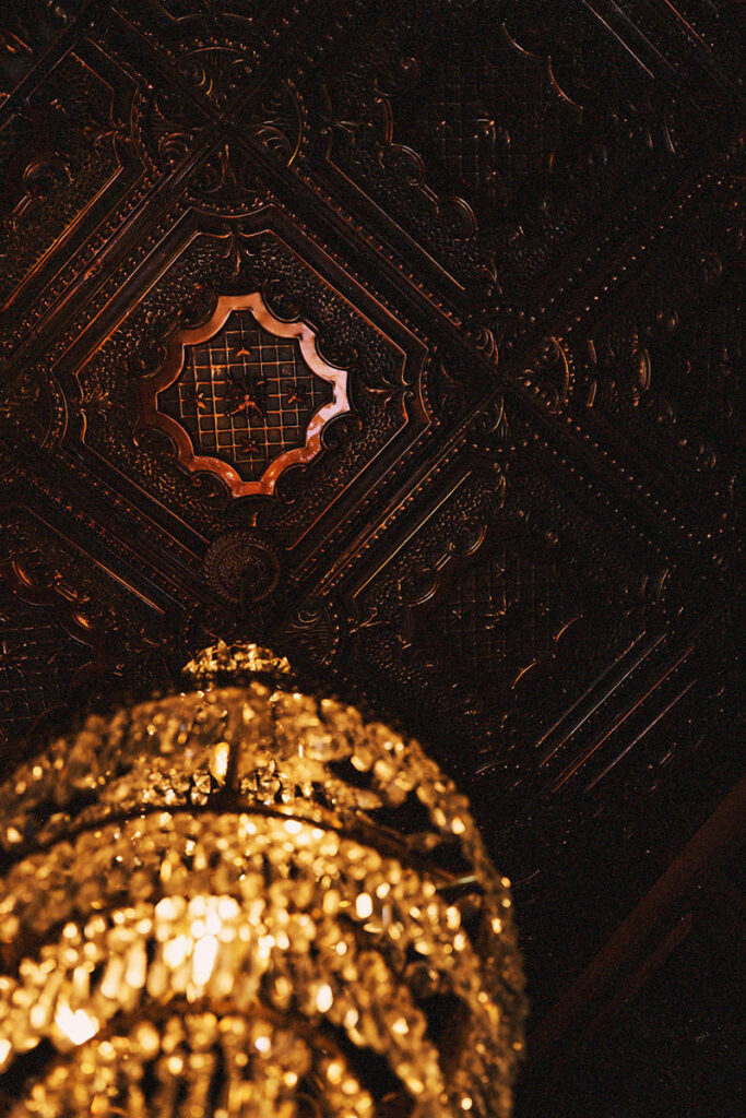 Ornate ceiling with hanging chandelier.