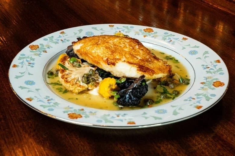 Pan-seared fish with vegetables and sauce